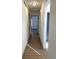 Bright hallway with hardwood floors and modern lighting leads to open rooms at 7101 W Yale Ave # 1206, Denver, CO 80227