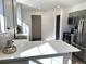 Kitchen island with white countertops and gray cabinets is well-lit by natural light at 7101 W Yale Ave # 1206, Denver, CO 80227