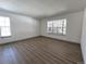 Bright living room featuring hardwood floors and a bay window at 7101 W Yale Ave # 1206, Denver, CO 80227