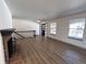 Spacious living room featuring stylish flooring, black railings, a brick fireplace and lots of natural light at 7101 W Yale Ave # 1206, Denver, CO 80227