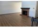 Cozy living room featuring a brick fireplace, stylish floors, and seamless access to other living spaces at 7101 W Yale Ave # 1206, Denver, CO 80227