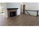 Hardwood floor living room with a brick fireplace at 7101 W Yale Ave # 1206, Denver, CO 80227