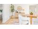 Dining area with wood table, white chairs, and stylish decor at 14129 W Center Dr, Lakewood, CO 80228