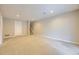 This spacious finished basement has neutral carpet, painted walls, a door to storage, and stairs leading up at 45 Wright Ct, Lakewood, CO 80228