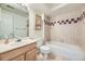 This neutral bathroom features a shower over tub with decorative checkered tile accents and a single sink at 45 Wright Ct, Lakewood, CO 80228