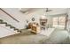 Cozy living room with a fireplace, stairs, and sliding doors that lead to the outdoors at 45 Wright Ct, Lakewood, CO 80228