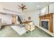 Bright living room featuring a fireplace, stairs, and comfortable seating, great for relaxing or entertaining at 45 Wright Ct, Lakewood, CO 80228