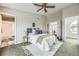 Large bedroom with ceiling fan and doors to ensuite bath and additional rooms at 45 Wright Ct, Lakewood, CO 80228