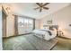 Bright main bedroom features a large window, ceiling fan and decorative rug at 45 Wright Ct, Lakewood, CO 80228