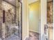 Bathroom featuring a tiled shower with glass doors and a built-in seat at 45 Wright Ct, Lakewood, CO 80228