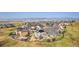 Panoramic aerial view showcasing the community nestled amidst rolling hills, with stunning mountain views in the background at 8551 Orchard Way, Arvada, CO 80007