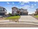 Charming two-story home features a well-maintained lawn and an expansive driveway leading to a two-car garage at 8551 Orchard Way, Arvada, CO 80007