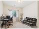 Bright office/bedroom with a futon, desk, and large window providing natural light and street views at 10818 Cimarron St # 1102, Firestone, CO 80504