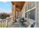 Charming porch with stone supports, seating, and view of the neighborhood at 10818 Cimarron St # 1102, Firestone, CO 80504