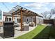 Backyard features an outdoor kitchen, grill, pergola, seating, and artificial grass at 1960 Wabash St, Denver, CO 80220