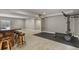 Finished basement including a bar area, carpeted flooring, and a home gym at 1960 Wabash St, Denver, CO 80220