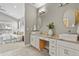 Bathroom with double vanity, modern fixtures, granite countertops, and access to main bedroom at 1960 Wabash St, Denver, CO 80220