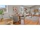 Open dining area features a wooden table, living room, and natural light from windows at 1960 Wabash St, Denver, CO 80220