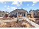 A charming single-story home featuring a welcoming porch and landscaped front yard at 1960 Wabash St, Denver, CO 80220