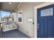 Close up of the home's porch, featuring a cozy porch swing, blue door, and modern mailbox enhancing curb appeal at 1960 Wabash St, Denver, CO 80220