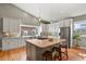 Modern kitchen with white cabinets, stainless steel appliances, and an island with wooden countertop at 1960 Wabash St, Denver, CO 80220