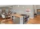 Open kitchen features a center island with a gas range cooktop and a dining area with a round wooden table at 1960 Wabash St, Denver, CO 80220