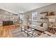 Bright, inviting living room with hardwood floors, chic decor, and an open concept that flows into the adjacent kitchen at 1960 Wabash St, Denver, CO 80220