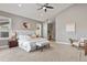 Spacious main bedroom featuring a ceiling fan, ensuite, and modern decor with a plush bench at 1960 Wabash St, Denver, CO 80220