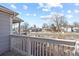 View of the quiet neighborhood from a charming front porch with a white railing at 1960 Wabash St, Denver, CO 80220