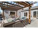 Relaxing outdoor space with a covered patio, complete with comfortable seating, bar, and a pass-through window at 1960 Wabash St, Denver, CO 80220