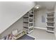 Unfinished storage space with shelving units and sloped ceiling for organization at 1960 Wabash St, Denver, CO 80220