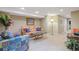 Finished basement with neutral carpet, comfortable seating, and a decorative lamp at 2 S Monroe St, Denver, CO 80209