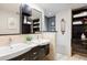Bathroom features double sinks, a large mirror, and ample cabinet space at 2 S Monroe St, Denver, CO 80209