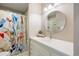 Bathroom featuring a white vanity, bright lighting, and a colorful shower curtain at 2 S Monroe St, Denver, CO 80209