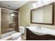 Bathroom featuring a glass shower door, tile surround, vanity, and tiled floor at 2 S Monroe St, Denver, CO 80209