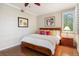 Cozy bedroom with a ceiling fan, hardwood floors, and a window with plantation shutters at 2 S Monroe St, Denver, CO 80209
