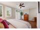 Bedroom with plantation shutters, a ceiling fan, and a view of the backyard at 2 S Monroe St, Denver, CO 80209