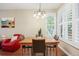 Bright dining area with wooden table, chairs, chandelier, and plantation shutters at 2 S Monroe St, Denver, CO 80209