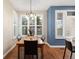 Dining area featuring a wooden table, chairs, plantation shutters, and natural light at 2 S Monroe St, Denver, CO 80209