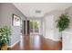 Bright hallway featuring wood floors, plant decorations, and a sliding glass door to the balcony at 2 S Monroe St, Denver, CO 80209
