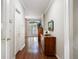 Hallway with hardwood floors and views of the living room with plantation shutters at 2 S Monroe St, Denver, CO 80209