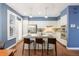 Well-lit kitchen with white cabinets, stainless steel appliances, and an island with barstool seating at 2 S Monroe St, Denver, CO 80209
