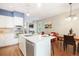 Open kitchen with white cabinets, stainless steel appliances, island, and hardwood floors at 2 S Monroe St, Denver, CO 80209