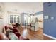 Open-concept layout featuring a dining area, kitchen, and living room with red armchairs at 2 S Monroe St, Denver, CO 80209