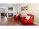 Stylish living room featuring a cozy fireplace, red armchairs, and modern decor at 2 S Monroe St, Denver, CO 80209