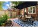 Charming patio area featuring a tile table and six chairs underneath a large umbrella at 2 S Monroe St, Denver, CO 80209