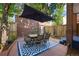 Charming patio area featuring a tile table and six chairs underneath a large umbrella at 2 S Monroe St, Denver, CO 80209