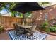 Charming patio area featuring a tile table and six chairs underneath a large umbrella at 2 S Monroe St, Denver, CO 80209