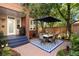 Private patio with brick paving, a dining set, and lush greenery; ideal for outdoor entertaining at 2 S Monroe St, Denver, CO 80209