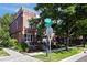 Charming brick townhomes near street sign with well-maintained landscaping and sidewalks at 2 S Monroe St, Denver, CO 80209